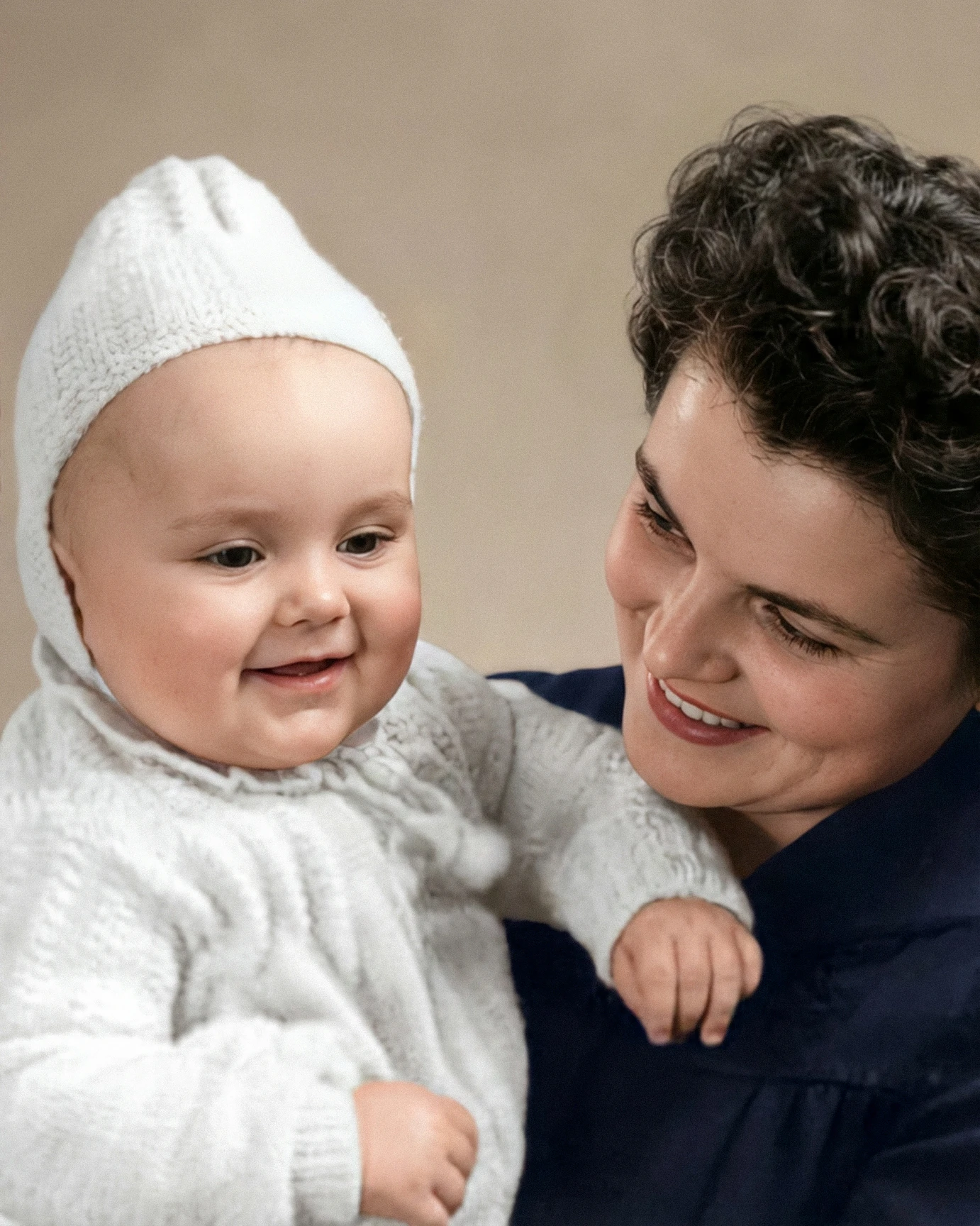 Restored photo of mother holding baby with scratches removed